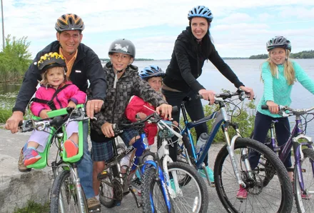 The McDougall family cycling beside Lake Scugog